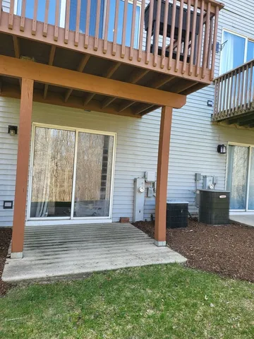 a view of a porch with a floor to ceiling window and a yard