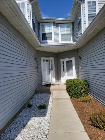 a view of a brick house with many windows