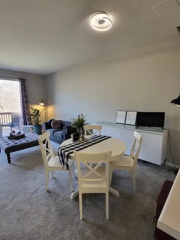 a dining room with furniture and wooden floor