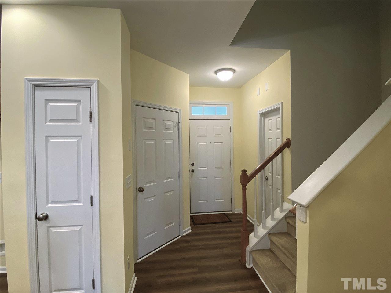 8235 Martello Lane Raleigh, NC 27613 - Photo 2 of 14 a view of a hallway with wooden floor and staircase