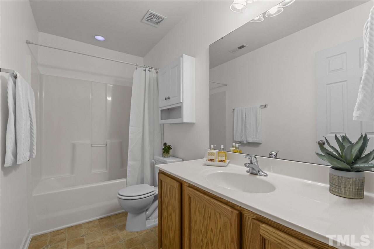 8235 Martello Lane Raleigh, NC 27613 - Photo 12 of 14 a bathroom with a sink toilet tub and shower