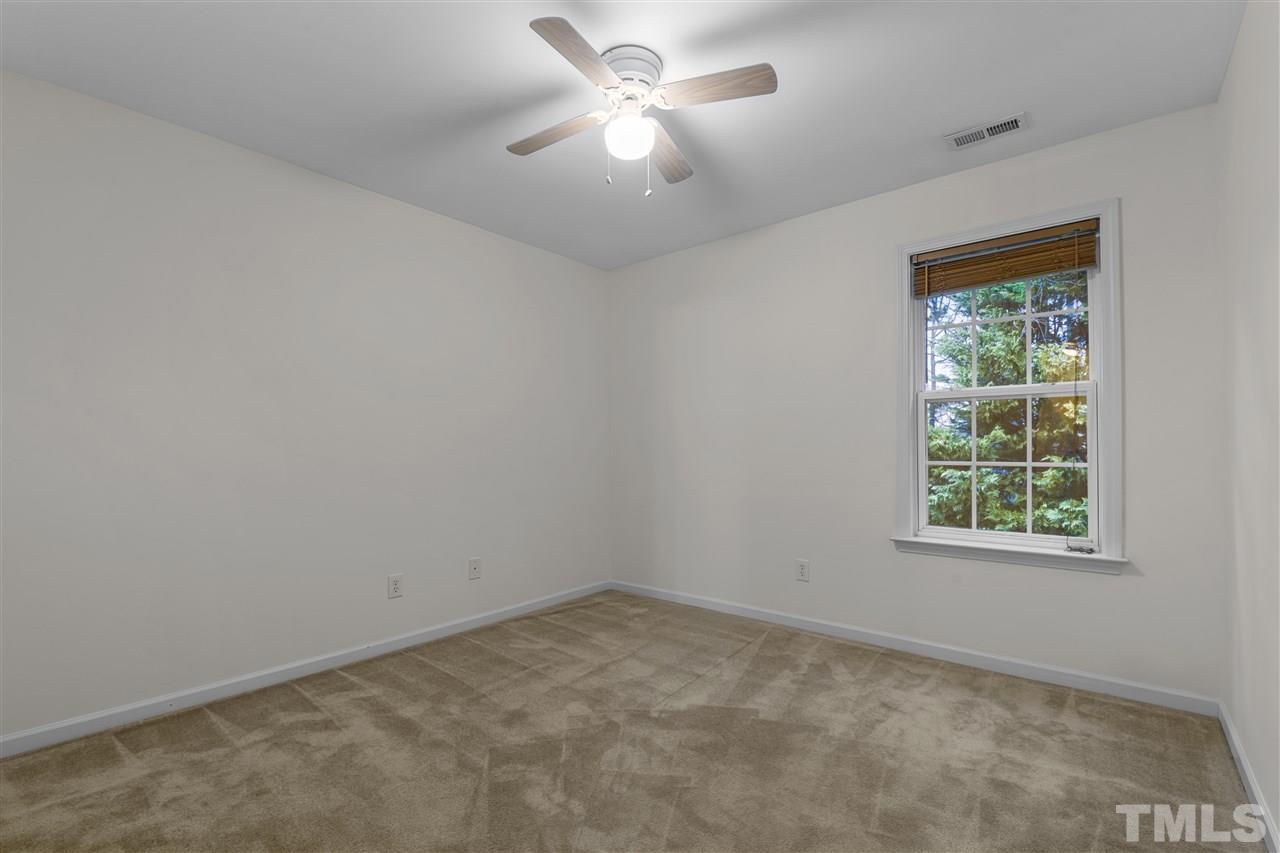 8235 Martello Lane Raleigh, NC 27613 - Photo 13 of 14 an empty room with a window and a fan