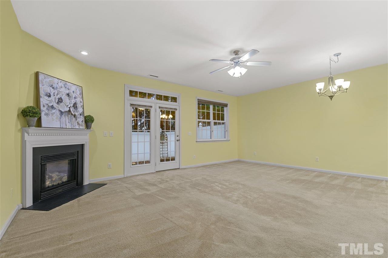 8235 Martello Lane Raleigh, NC 27613 - Photo 3 of 14 a view of an empty room with a fireplace