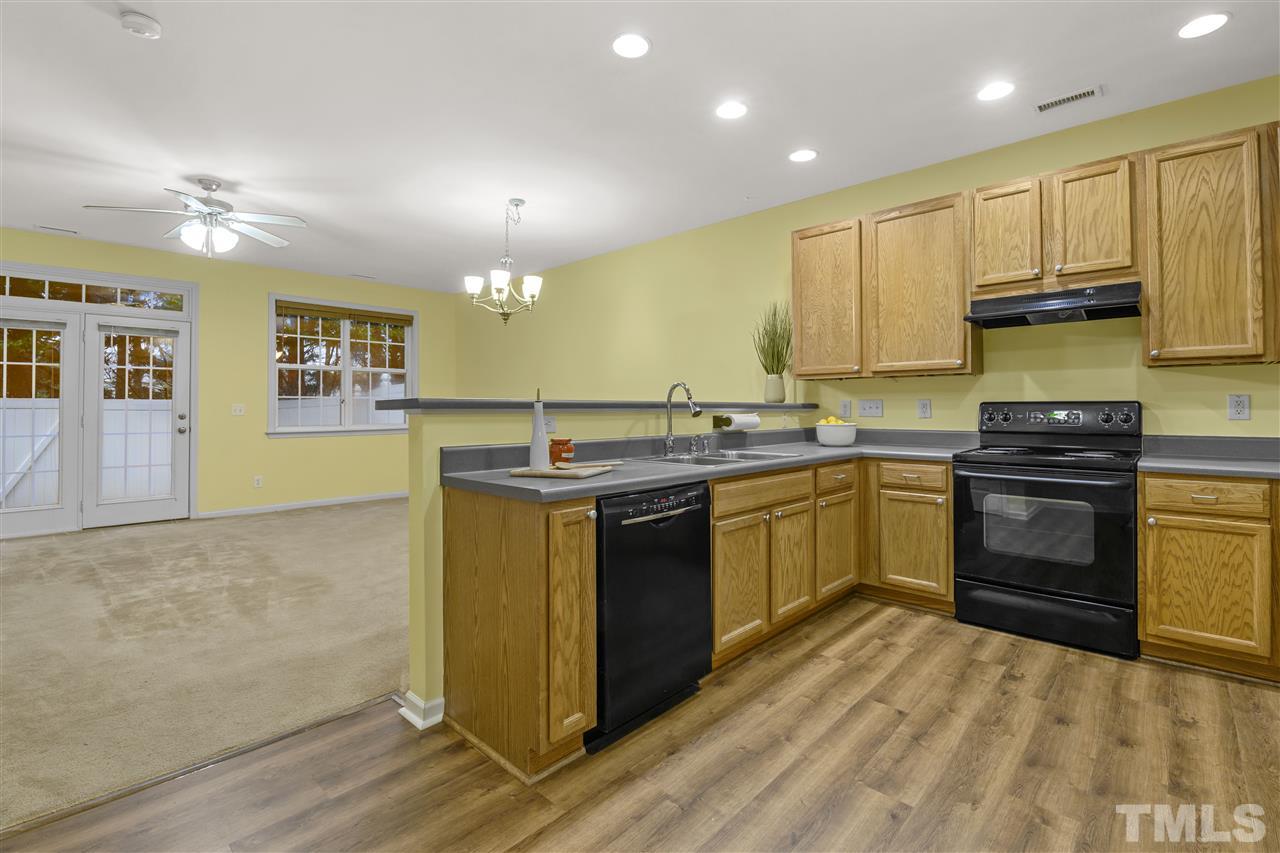 8235 Martello Lane Raleigh, NC 27613 - Photo 6 of 14 a kitchen with a sink stove and cabinets