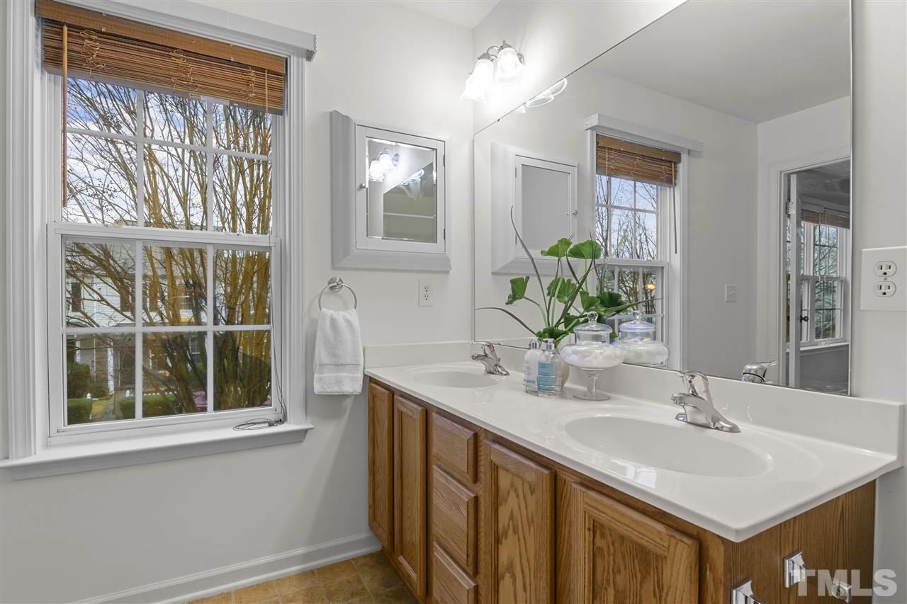 8235 Martello Lane Raleigh, NC 27613 - Photo 9 of 14 a bathroom with a sink and a mirror