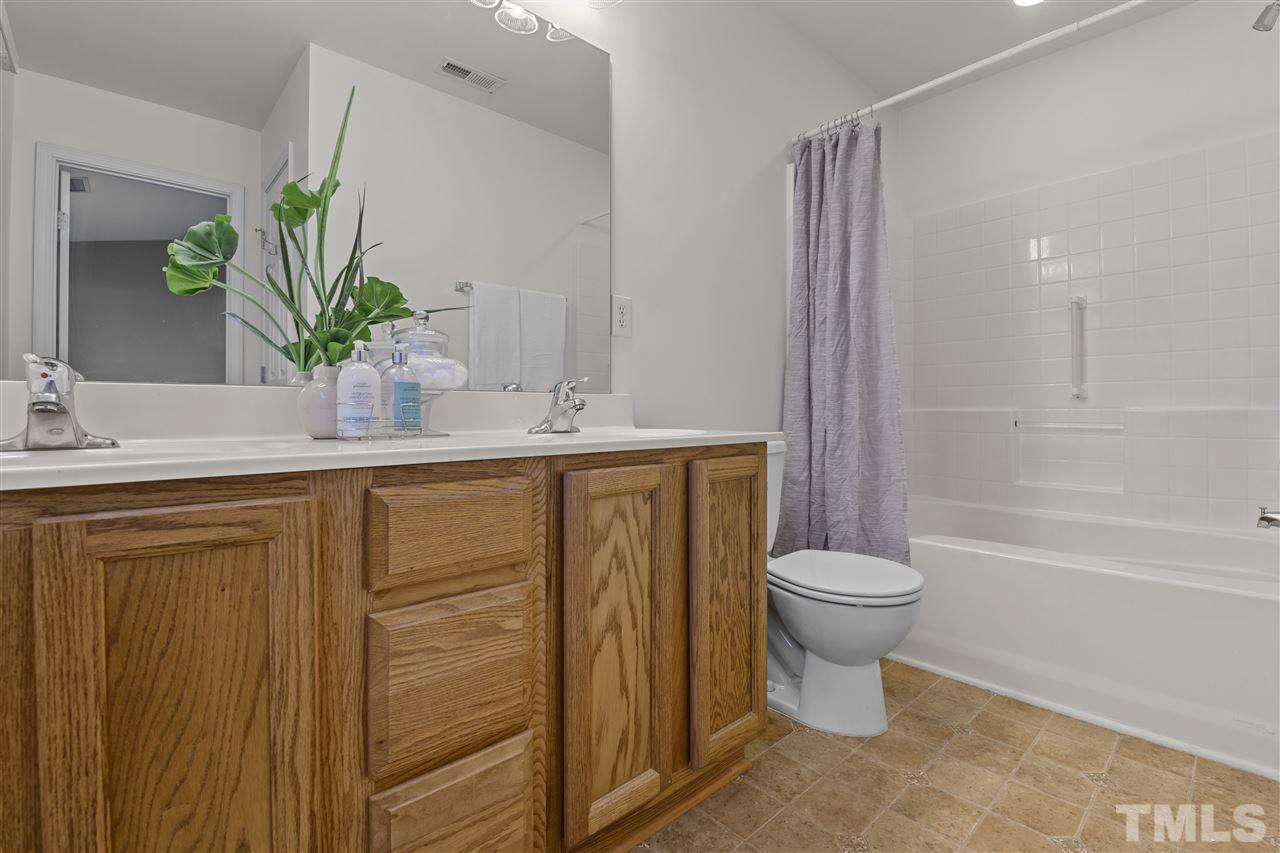 8235 Martello Lane Raleigh, NC 27613 - Photo 10 of 14 a bathroom with a sink a toilet and shower
