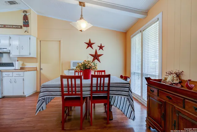 a view of a dining room with furniture window and wooden floor