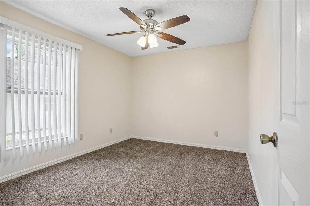 2596 Alclobe Circle Ocoee, FL 34761 - Photo 49 of 70 an empty room with a window and a ceiling fan