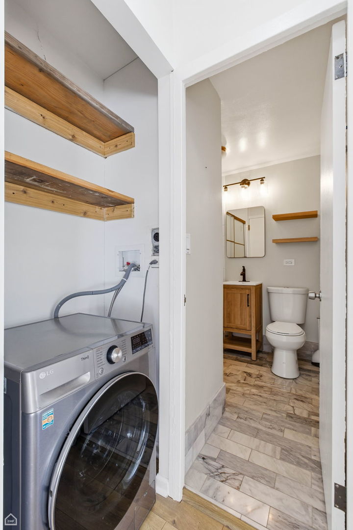 2930 North Sheridan Road, Unit 302 Chicago, IL 60657 - Photo 8 of 14 a view of a hallway with washer and dryer