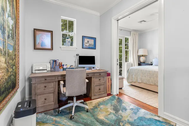 a view of a workspace with furniture and a window