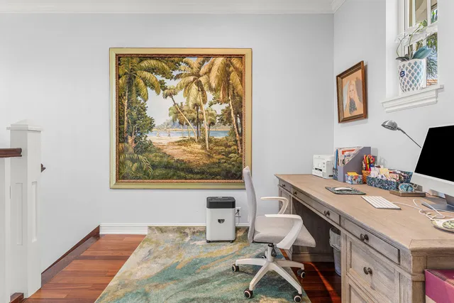 a spacious bedroom with a bed a couch and a flat tv screen