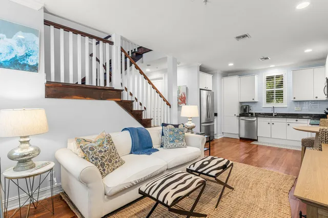 a living room with furniture and wooden floor