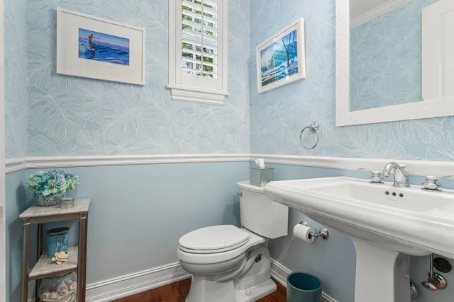 a bathroom with a sink mirror and toilet