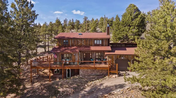 an aerial view of a house with yard and lake view