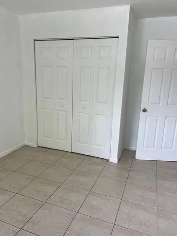 an empty room with cabinet and a bathroom