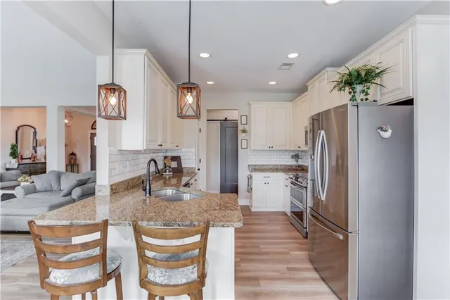a kitchen with refrigerator and microwave