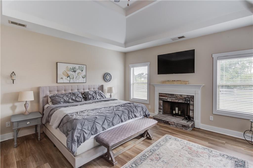 612 Quail Court Good Hope, GA 30641 - Photo 16 of 40 a spacious bedroom with a bed and a fireplace