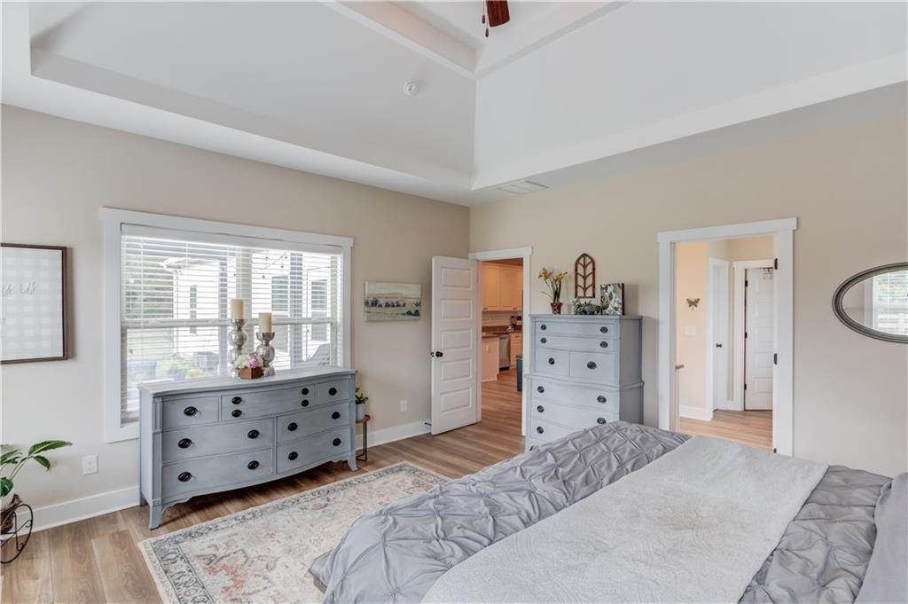 612 Quail Court Good Hope, GA 30641 - Photo 17 of 40 a spacious bedroom with a bed and wooden floor