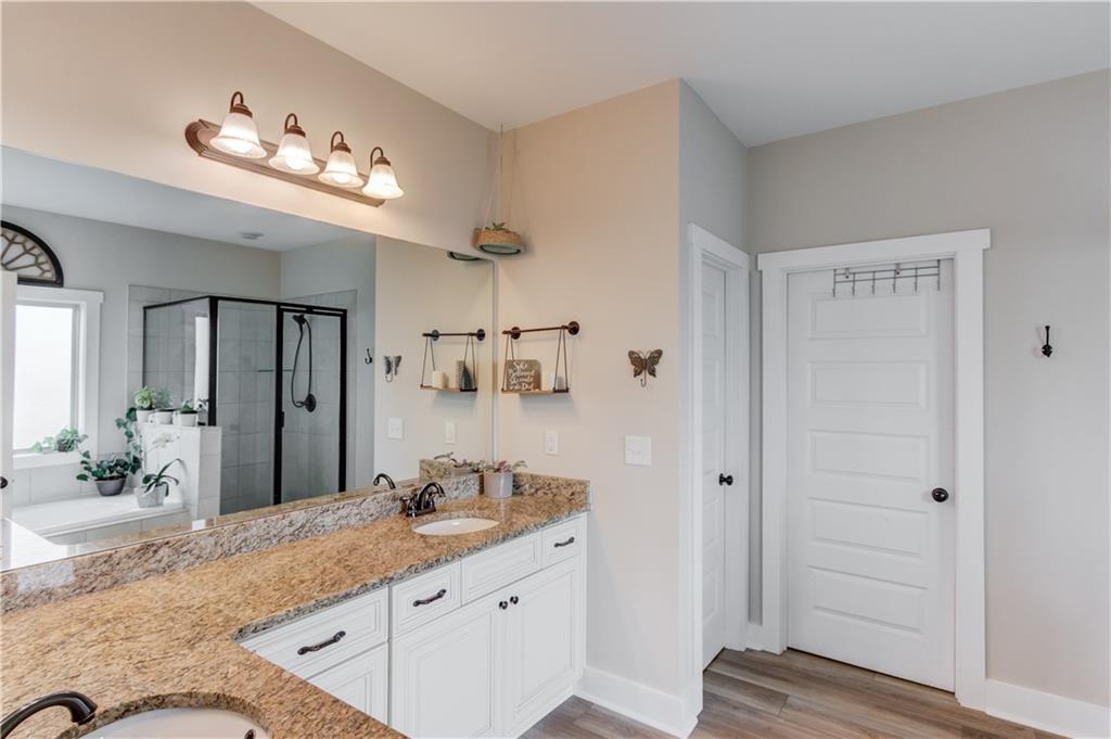 612 Quail Court Good Hope, GA 30641 - Photo 18 of 40 a bathroom with a granite countertop sink mirror and shower