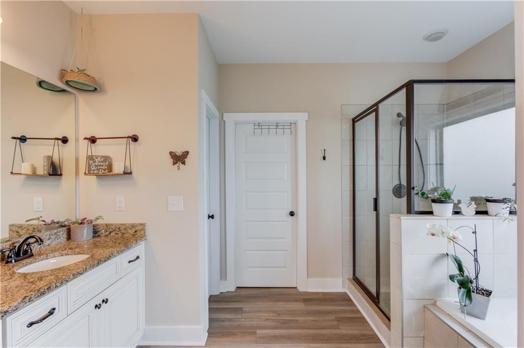 612 Quail Court Good Hope, GA 30641 - Photo 19 of 40 a bathroom with a granite countertop sink and a mirror