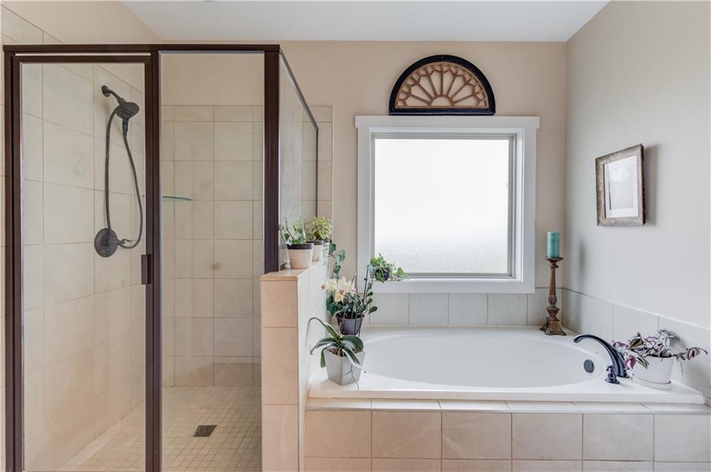 612 Quail Court Good Hope, GA 30641 - Photo 20 of 40 a bathroom with a bathtub a shower and a sink