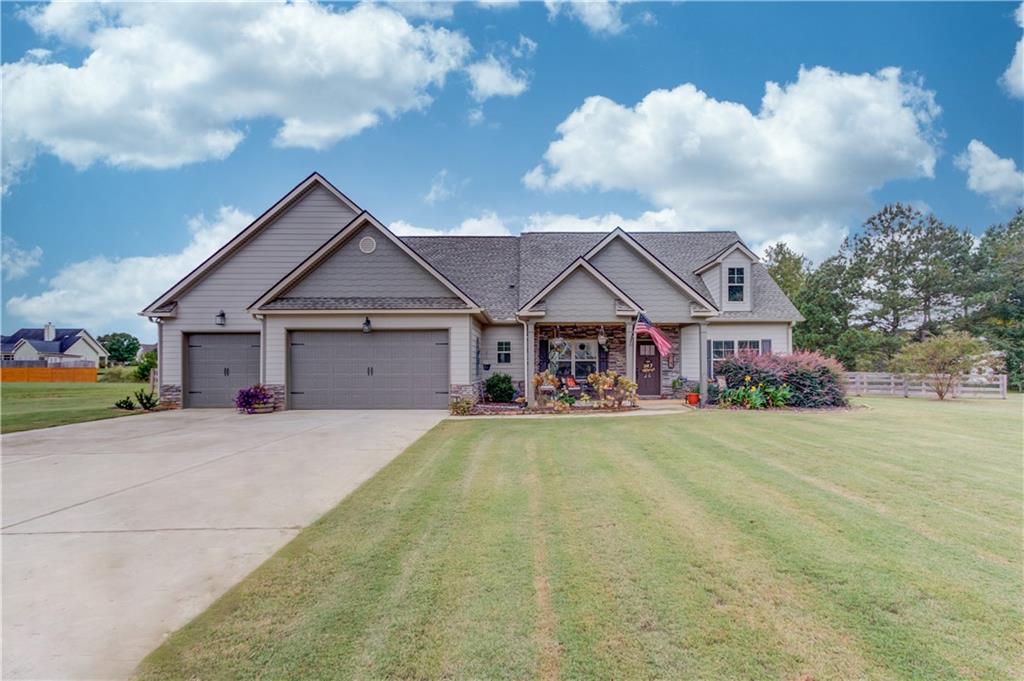 612 Quail Court Good Hope, GA 30641 - Photo 2 of 40 a front view of house with yard and trees in the background