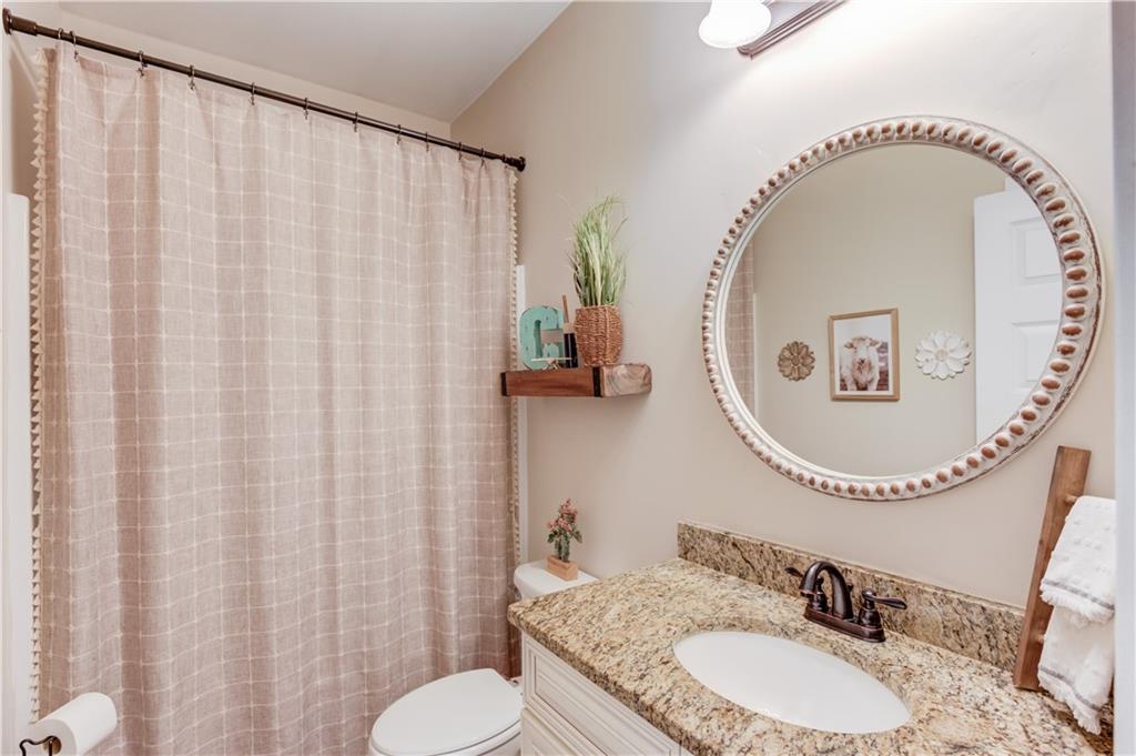 612 Quail Court Good Hope, GA 30641 - Photo 23 of 40 a bathroom with a sink mirror and a toilet