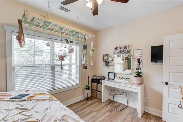 a bedroom with furniture and a flat screen tv