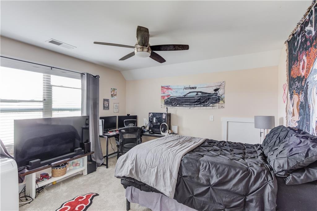 612 Quail Court Good Hope, GA 30641 - Photo 29 of 40 a bedroom with a bed and a flat tv screen on the dresser