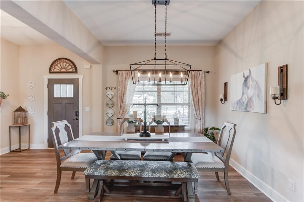 612 Quail Court Good Hope, GA 30641 - Photo 8 of 40 a view of a dining room with furniture window and wooden floor