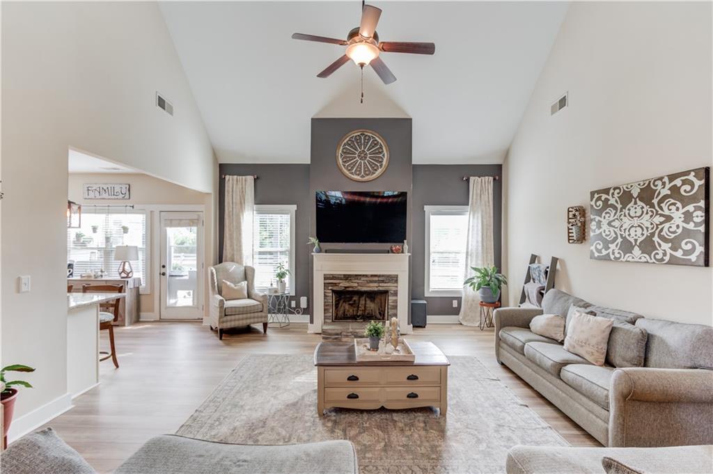 612 Quail Court Good Hope, GA 30641 - Photo 9 of 40 a living room with furniture a fireplace and a chandelier
