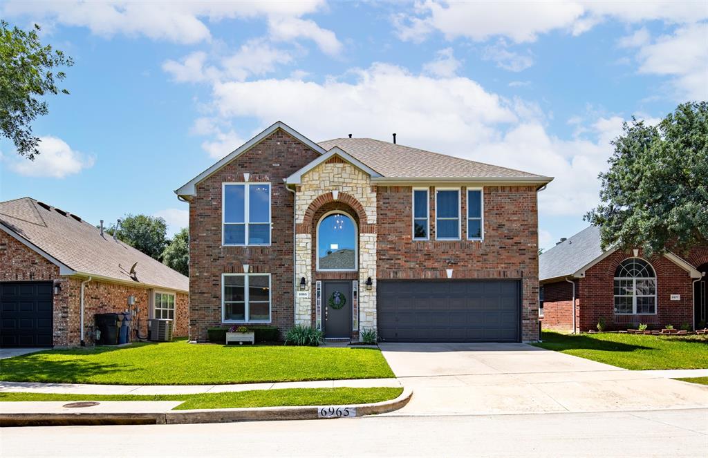6965 Stetson Way Frisco, TX 75034 - Photo 1 of 1 Two-story brick and stone facade featuring an arched entryway