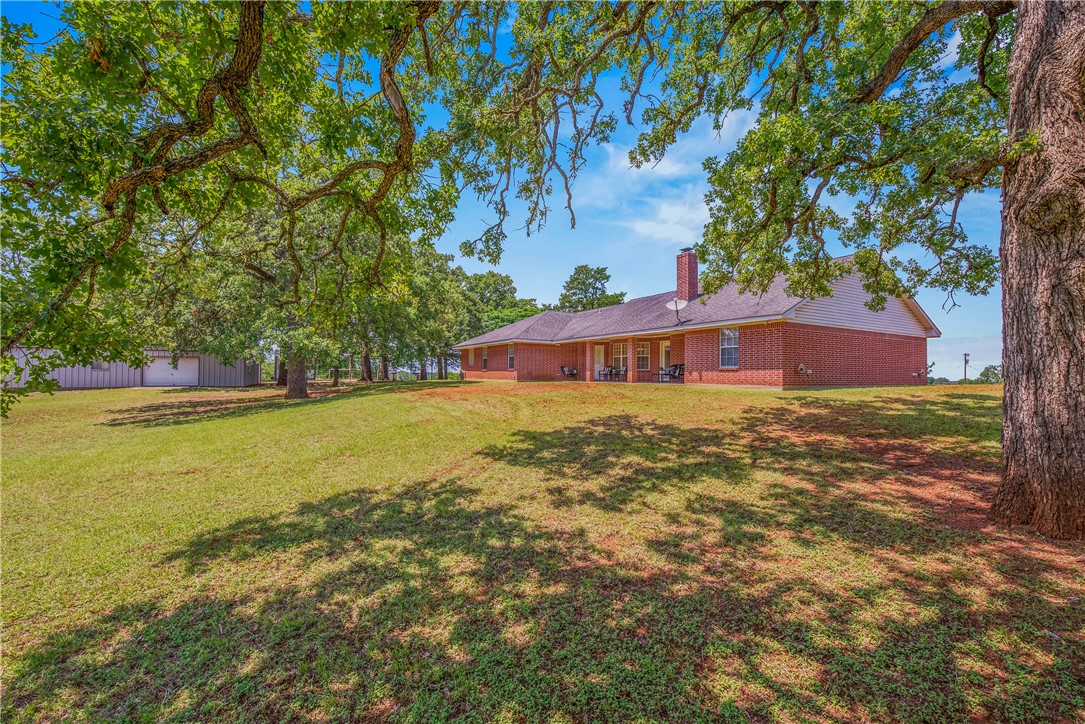 1110 County Road 439 Dime Box, TX 77853 - Photo 43 of 50 a view of a house with a yard and sitting area