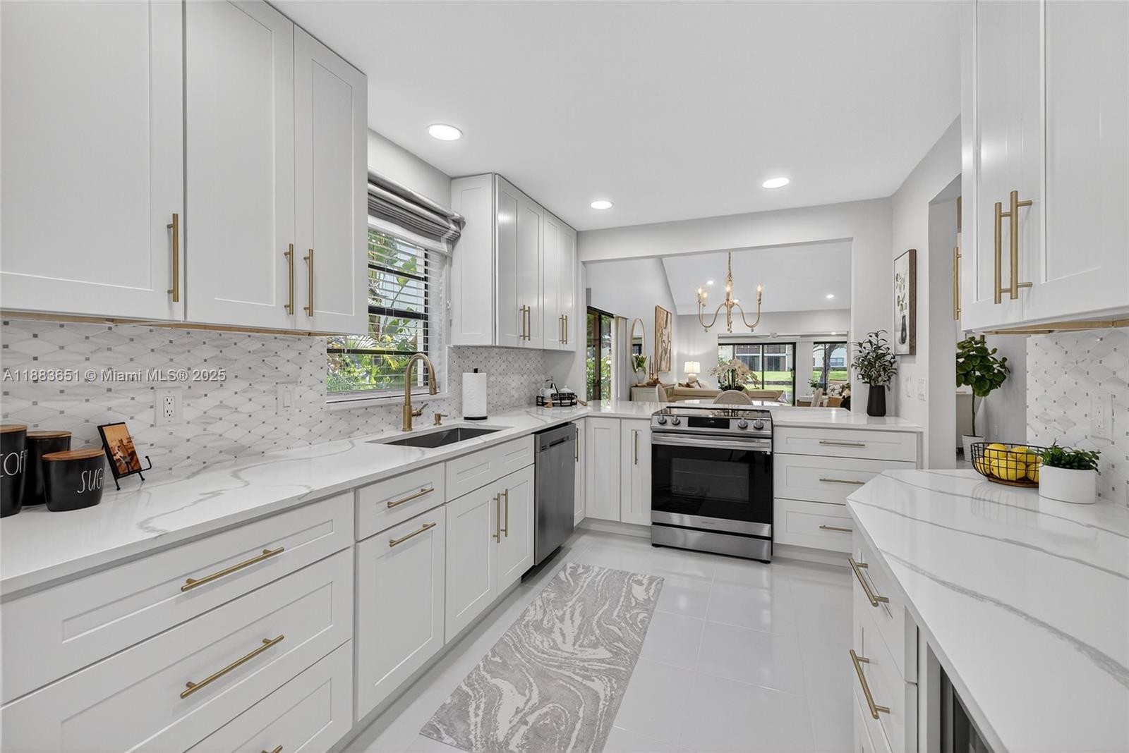 21695 Arriba Real Boca Raton, FL 33433 - Photo 15 of 61 a kitchen with a white stove cabinets and wooden floor