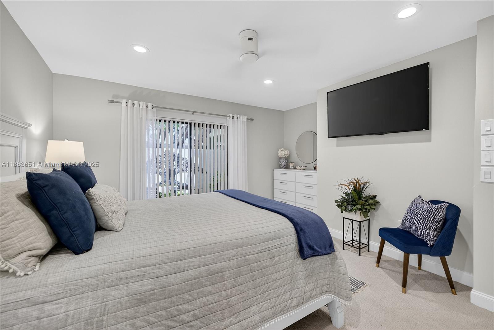 21695 Arriba Real Boca Raton, FL 33433 - Photo 31 of 61 a bedroom with a bed a chair and a flat screen television