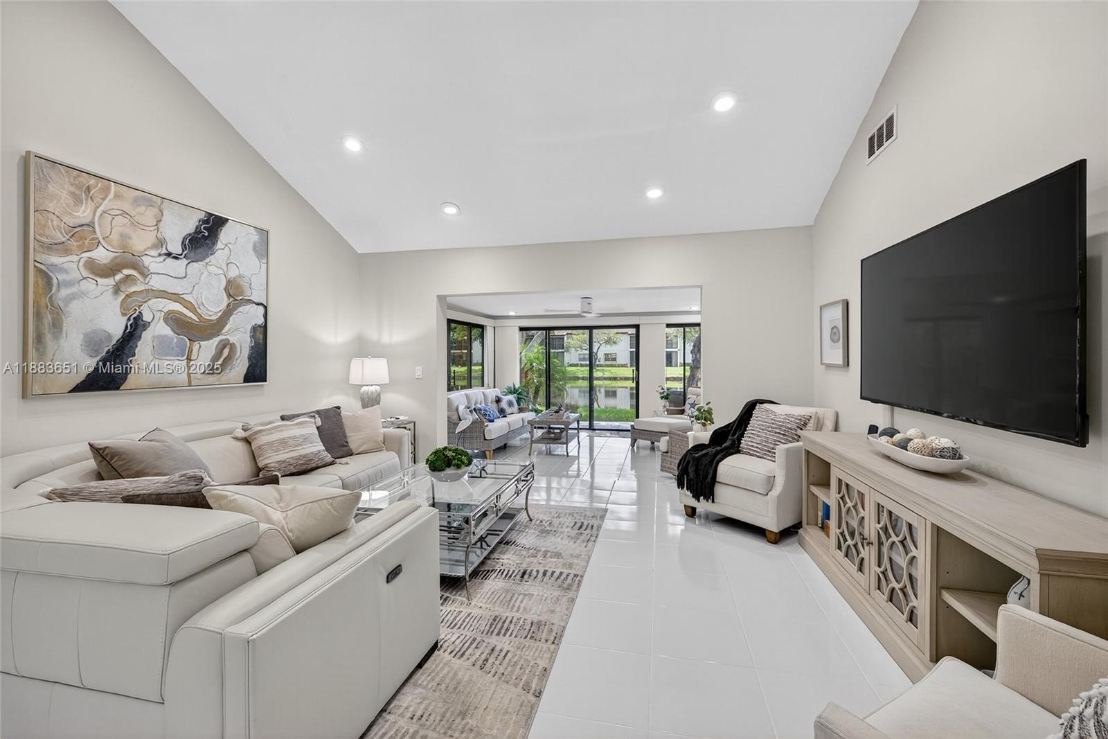 21695 Arriba Real Boca Raton, FL 33433 - Photo 4 of 61 a living room with furniture and a flat screen tv