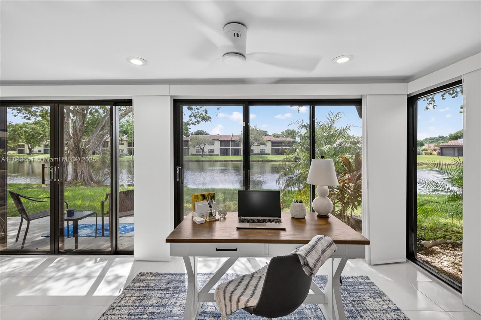 21695 Arriba Real Boca Raton, FL 33433 - Photo 41 of 61 a living room with furniture and a floor to ceiling window