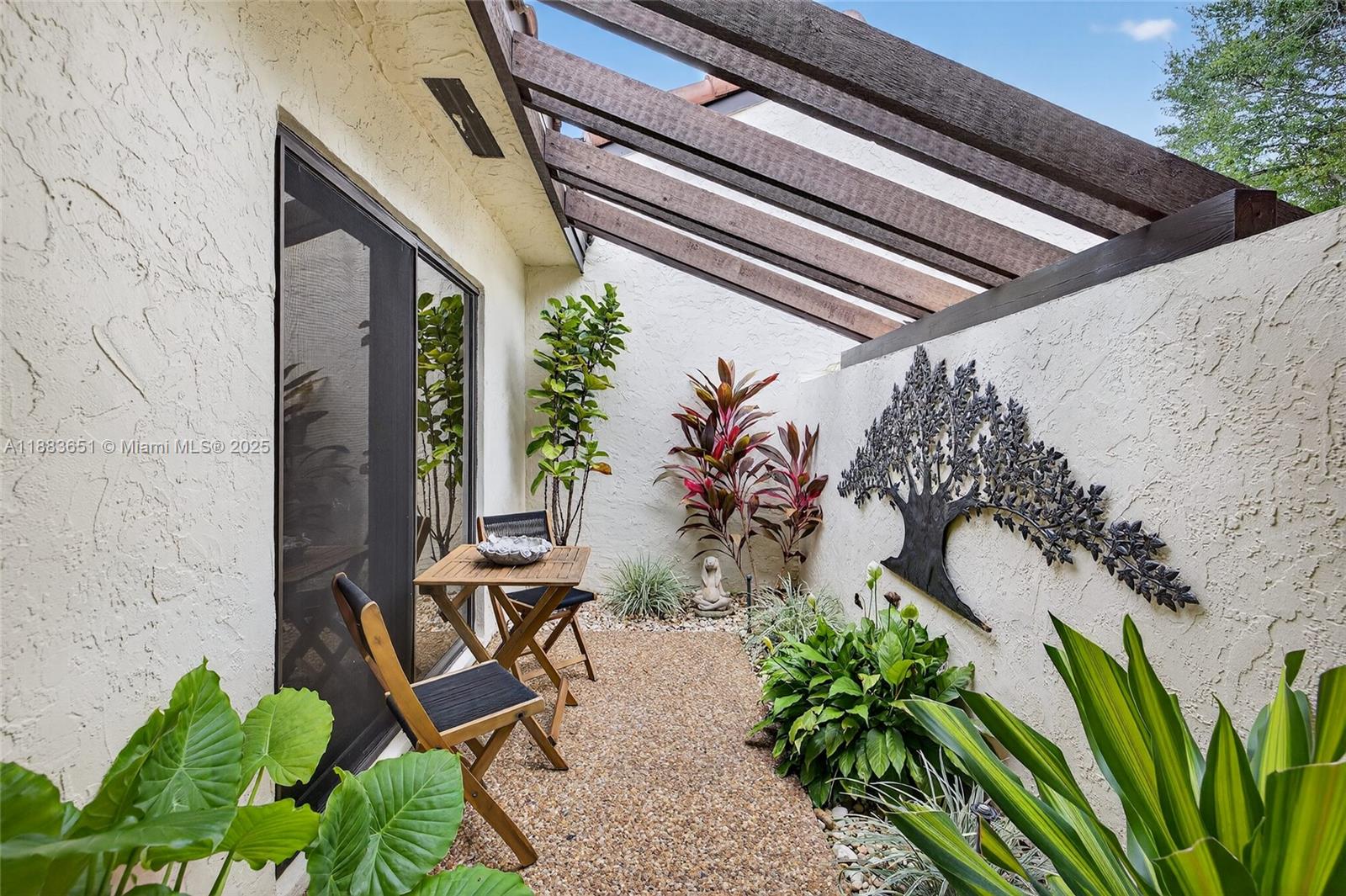 21695 Arriba Real Boca Raton, FL 33433 - Photo 42 of 61 a view of a backyard with chairs and a potted plant