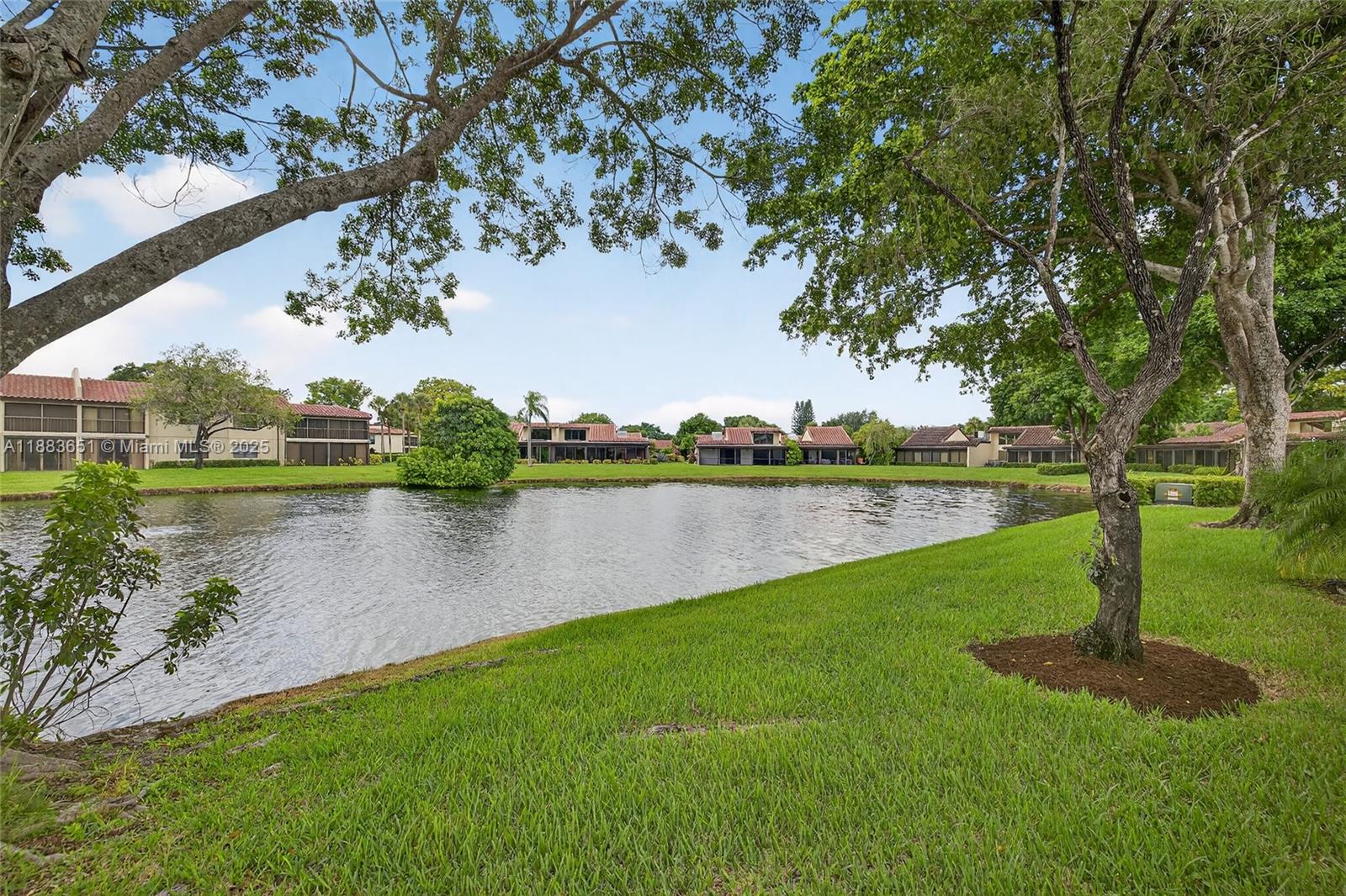 21695 Arriba Real Boca Raton, FL 33433 - Photo 47 of 61 a view of a lake with a yard and large trees