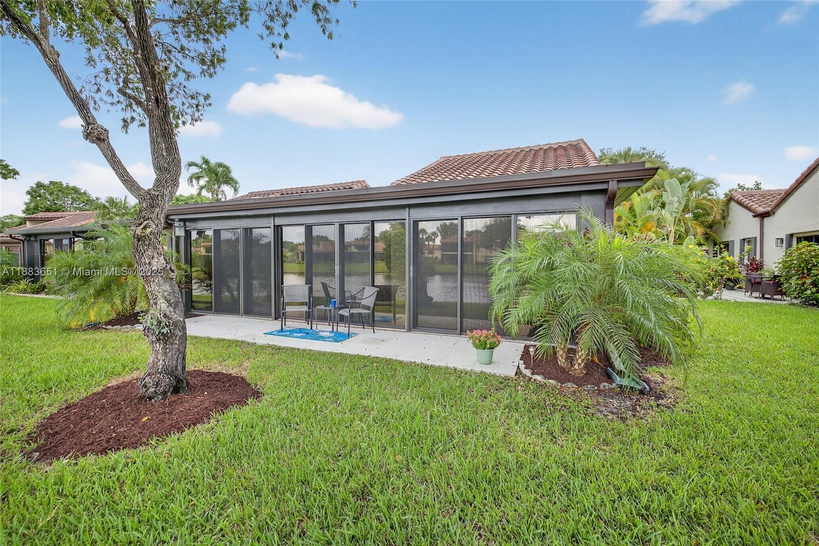 21695 Arriba Real Boca Raton, FL 33433 - Photo 48 of 61 a view of a house with backyard sitting area and garden