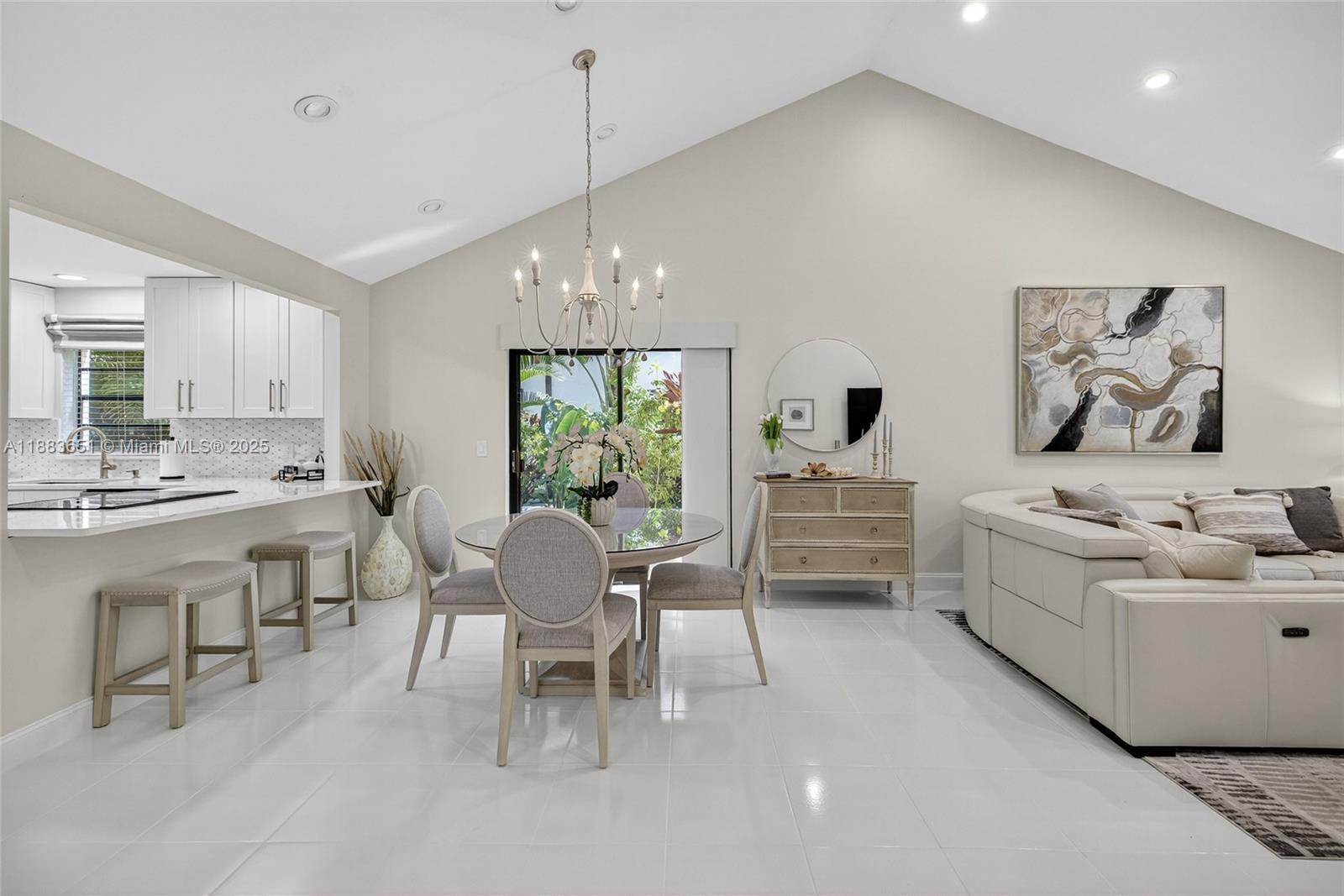 21695 Arriba Real Boca Raton, FL 33433 - Photo 5 of 61 a living room with furniture a dining table and a stove top oven