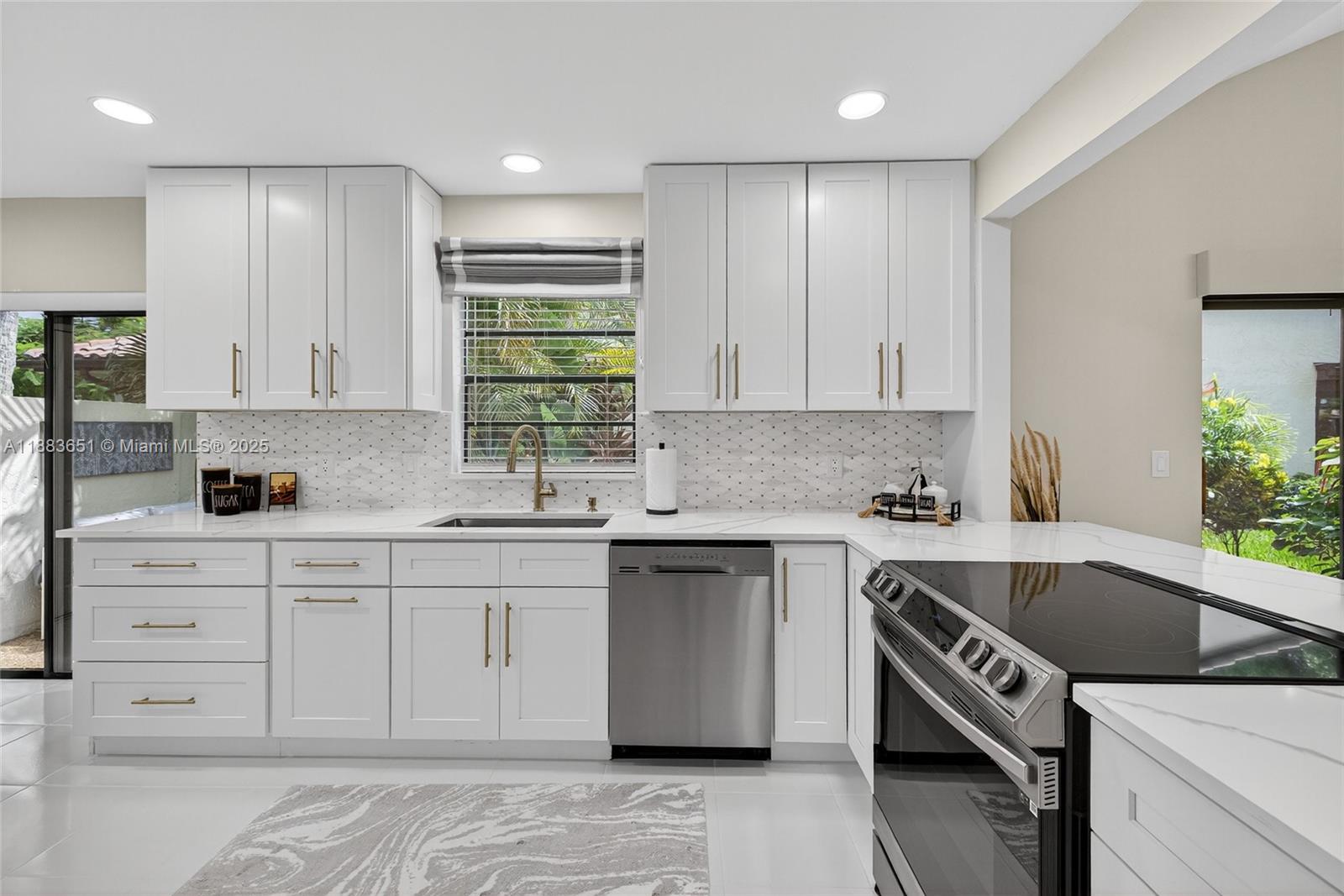 21695 Arriba Real Boca Raton, FL 33433 - Photo 8 of 61 a kitchen with a sink stove and cabinets