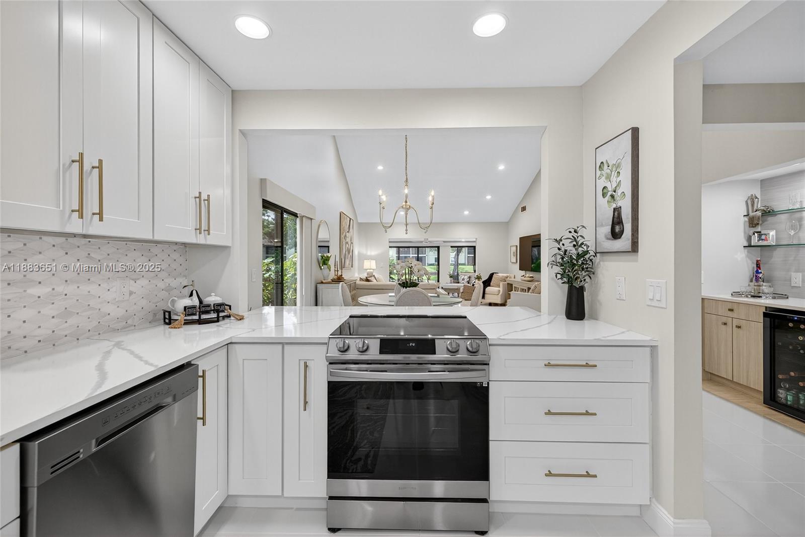 21695 Arriba Real Boca Raton, FL 33433 - Photo 10 of 61 a kitchen with stainless steel appliances granite countertop white cabinets and a stove