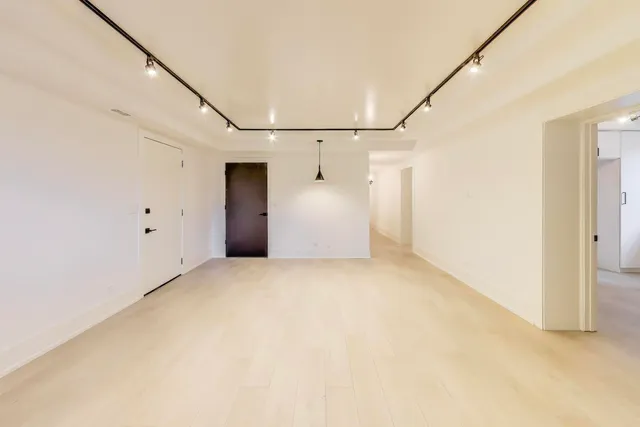 a view of a big room with closet and windows