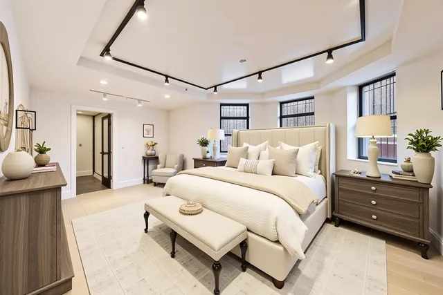 a spacious bedroom with a bed and a dresser