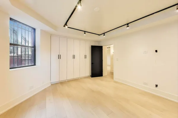 a view of a big room with cabinet and windows