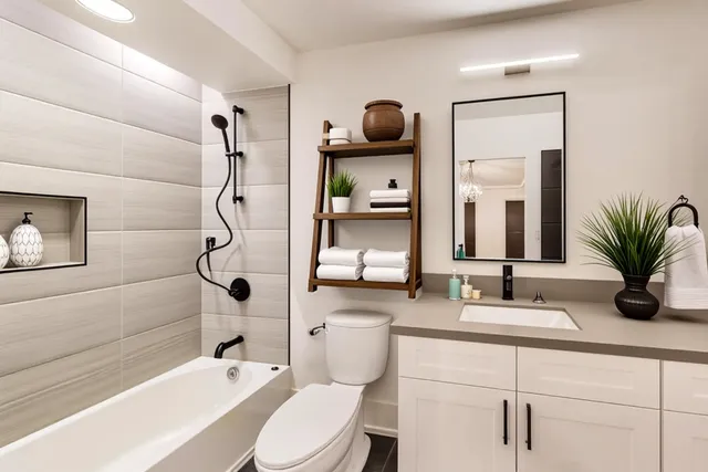 a bathroom with a sink a toilet and shower