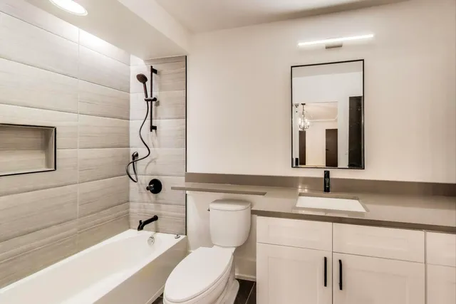 a view of an empty room with window and cabinet