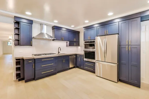 a kitchen with stainless steel appliances granite countertop a refrigerator oven a sink and dishwasher