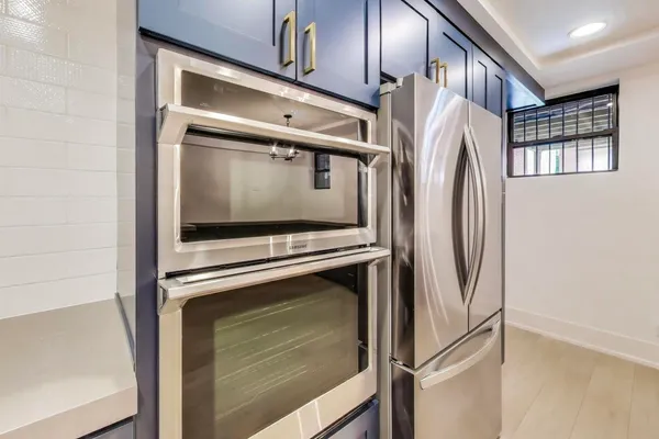 a kitchen with a refrigerator and cabinets